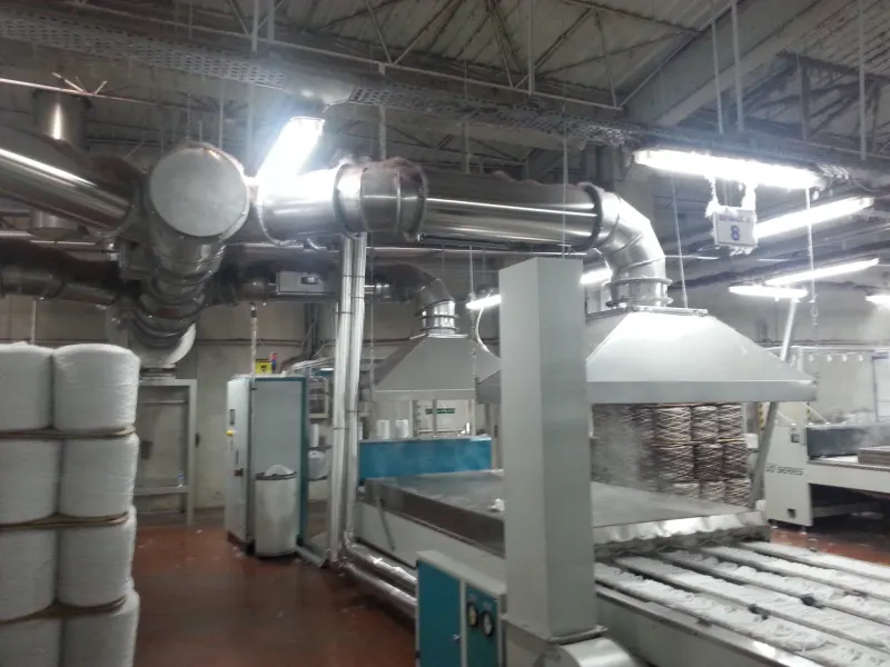 Hoods and extraction ducts over a textile line