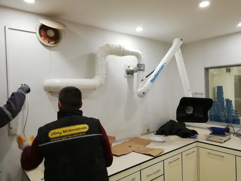 Installing an extraction arm in a laboratory